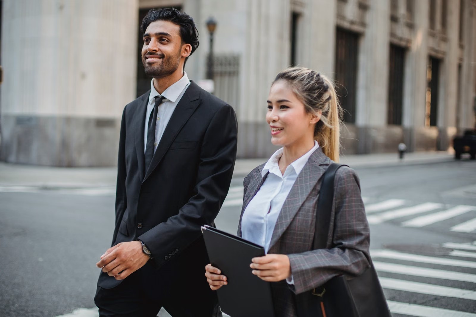 Business professionals walking through a city street