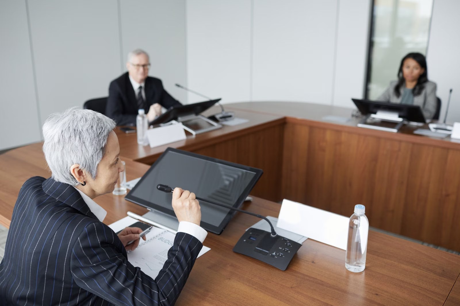 Executives in a governance meeting around a boardroom table