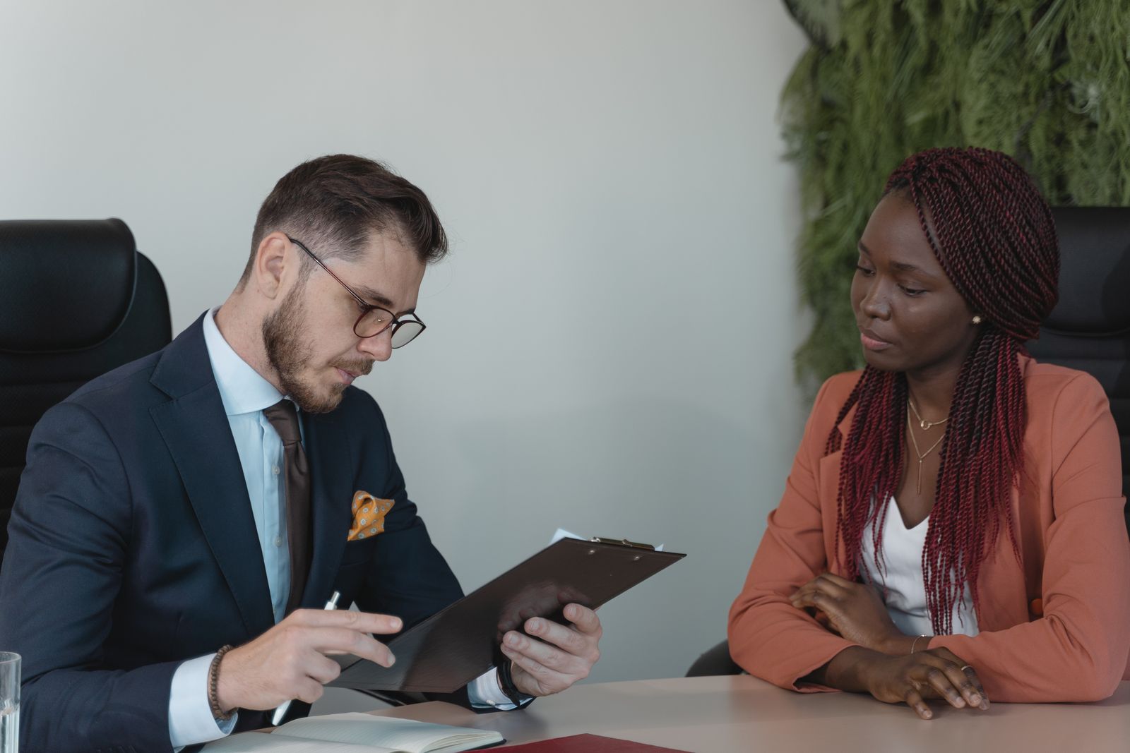 A recruiter and candidate in conversation over a resume