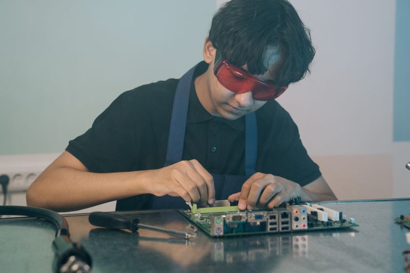 A technician working on a circuit board
