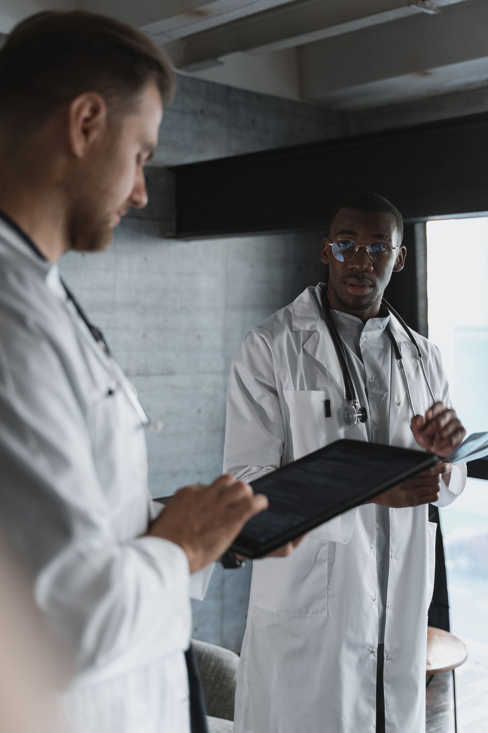 Two clinicians reviewing patient information on a tablet