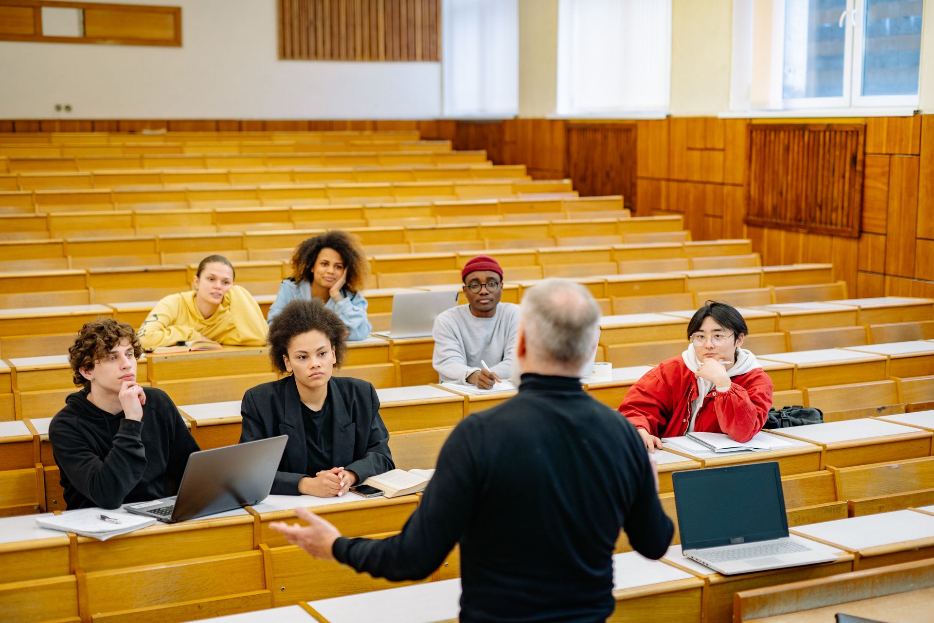 A professor teaching students in a university lecture hall