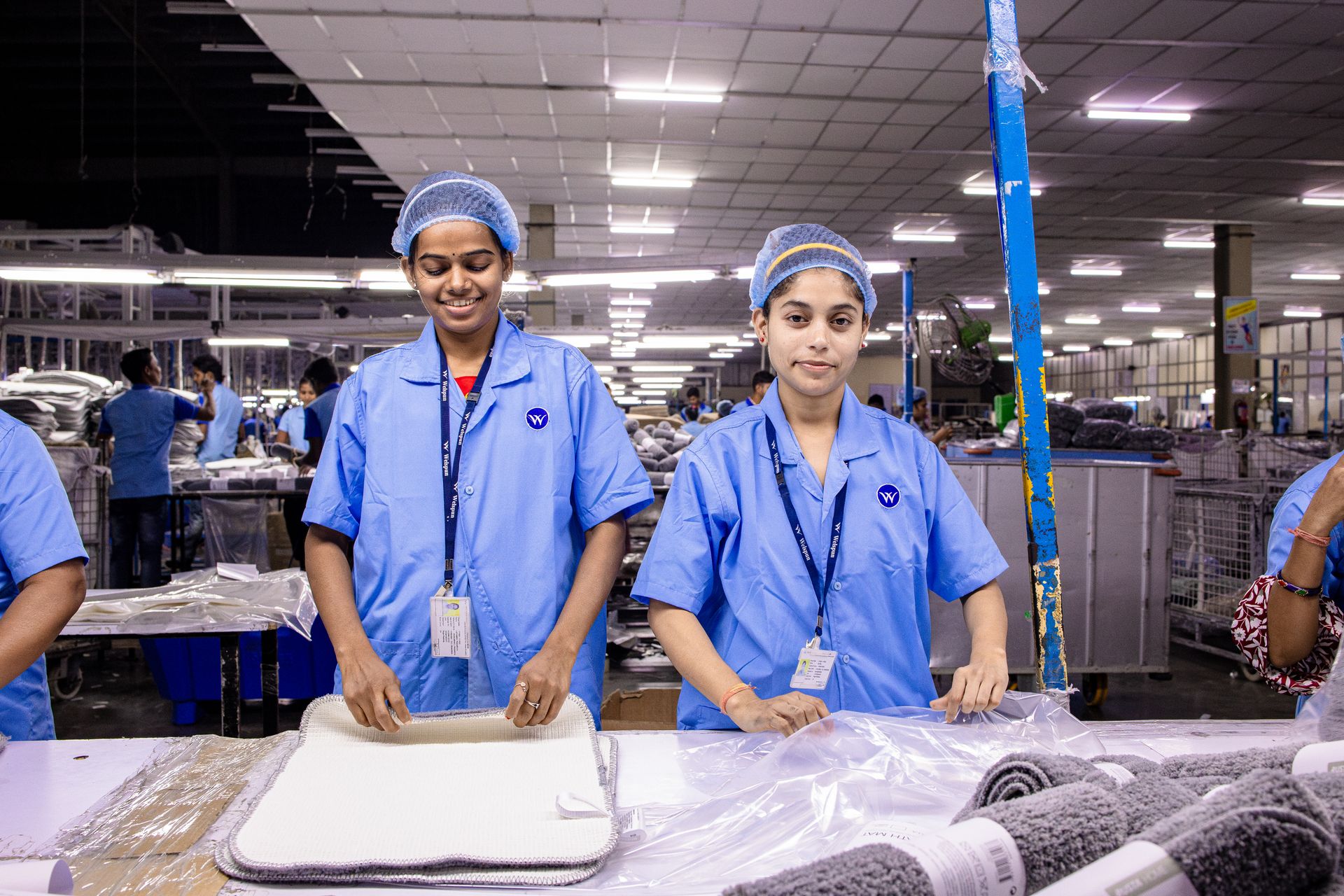 Workers in uniform on a modern factory floor