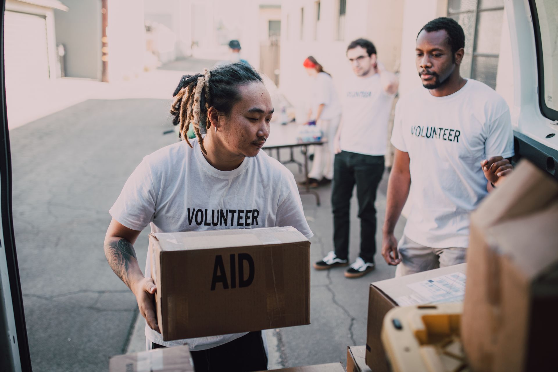 Volunteers unloading aid supplies from a van