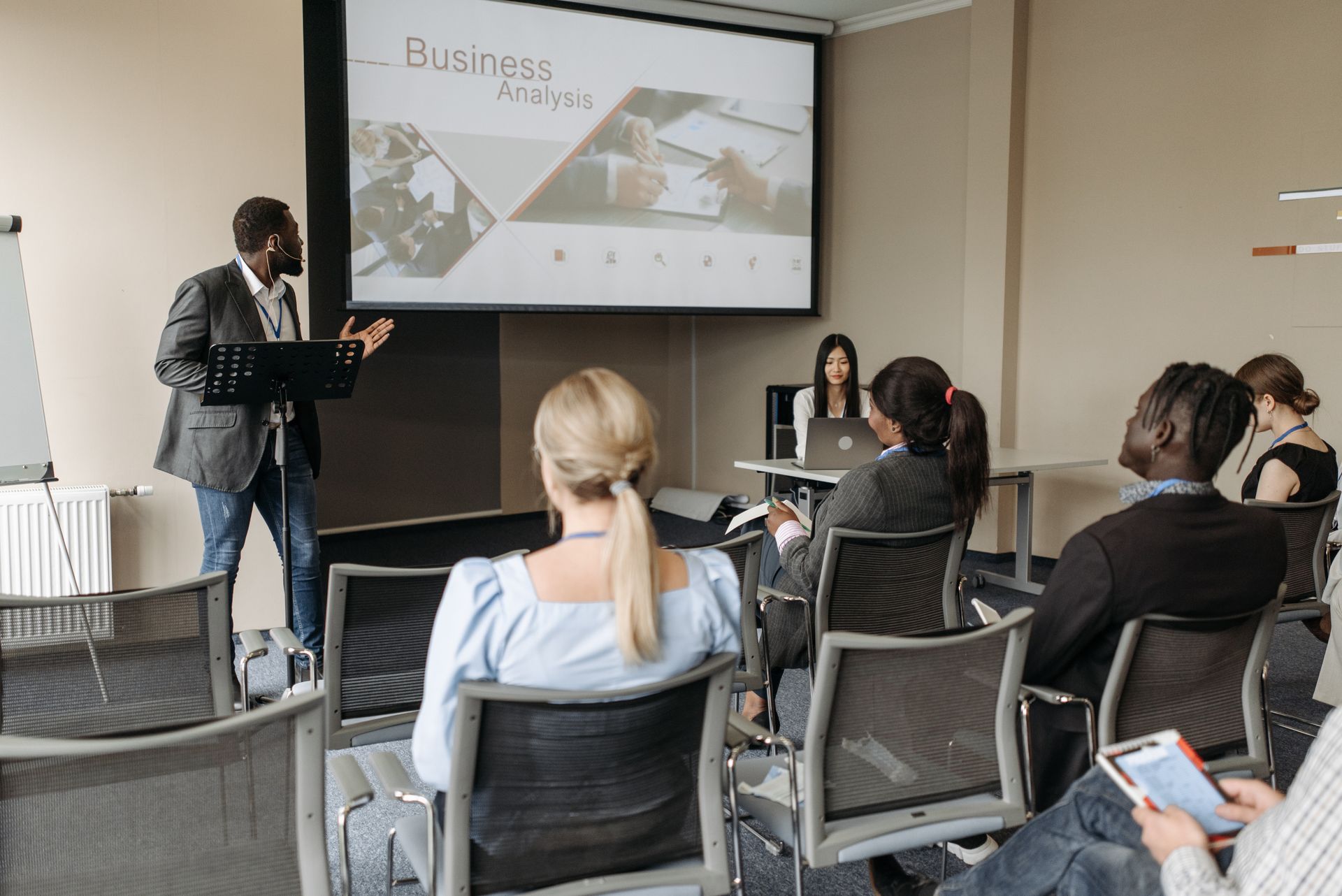 A presenter walking a seminar audience through an analysis on screen