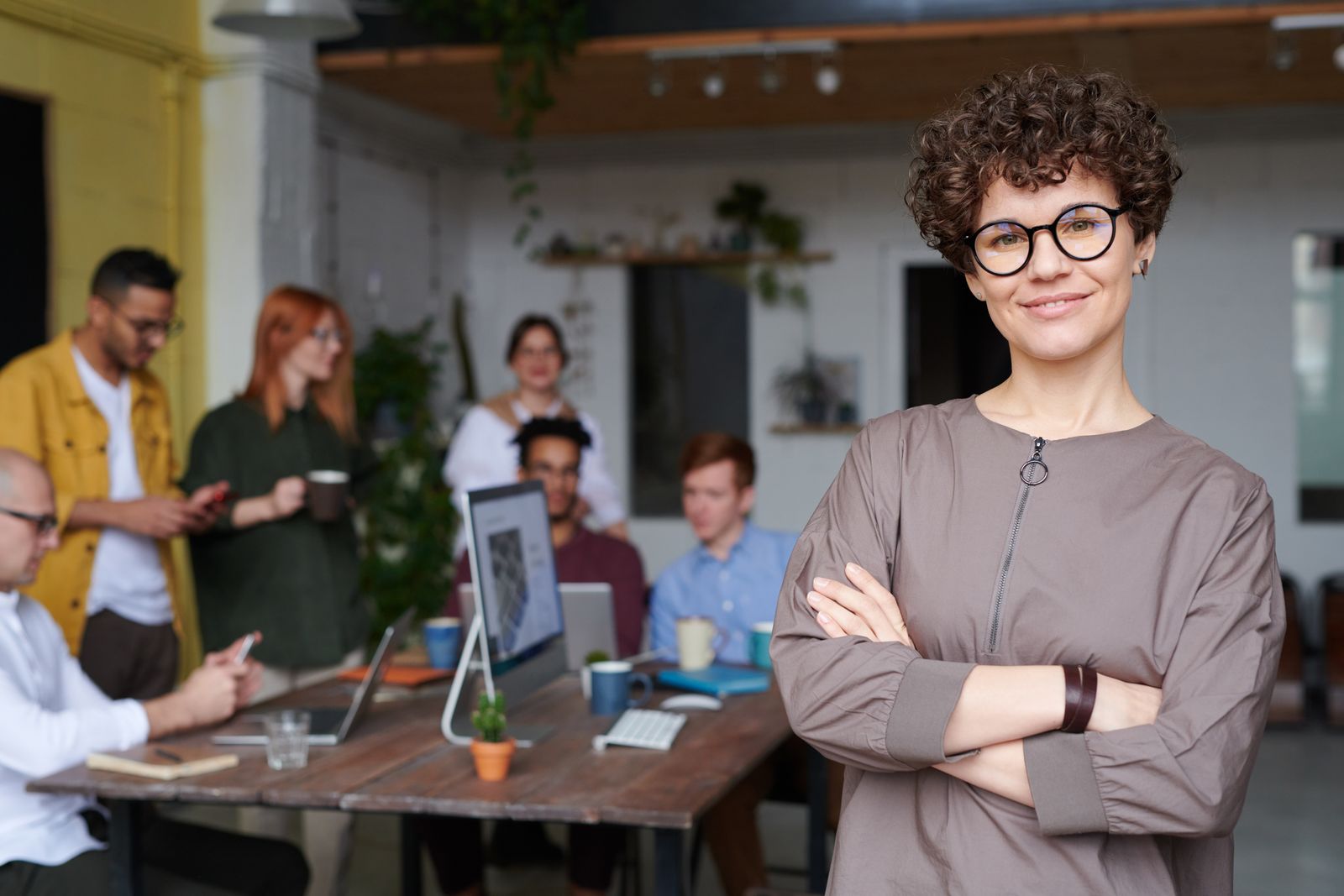 A smiling healthcare professional in front of her team