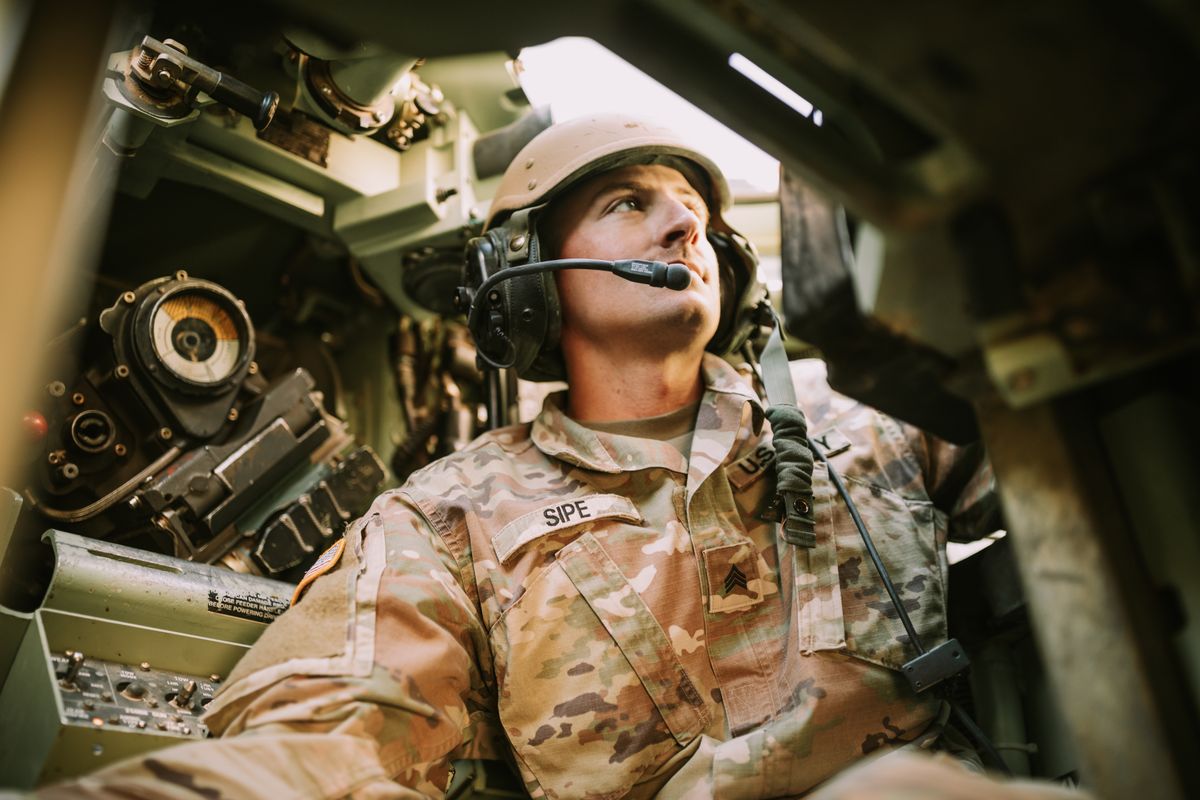 A specialist focused at work inside an armored vehicle