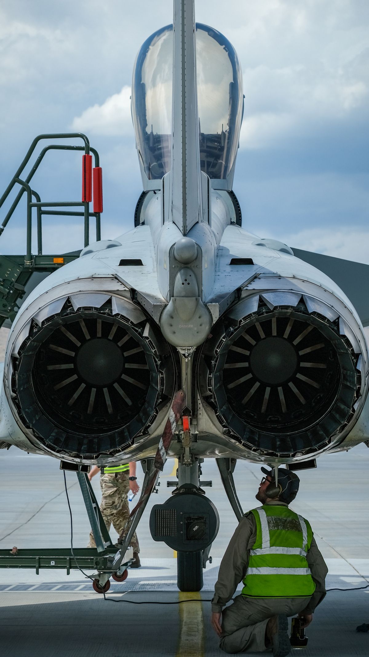An aeronautics engineer conducting a maintenance check on a jet engine